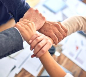 person in black long sleeve shirt holding persons hand